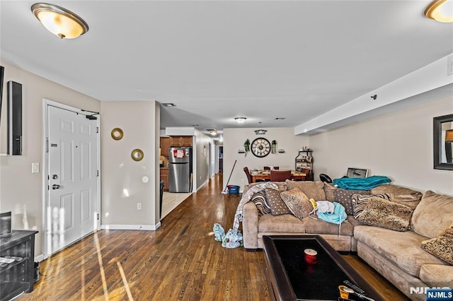 living area with baseboards and hardwood / wood-style floors