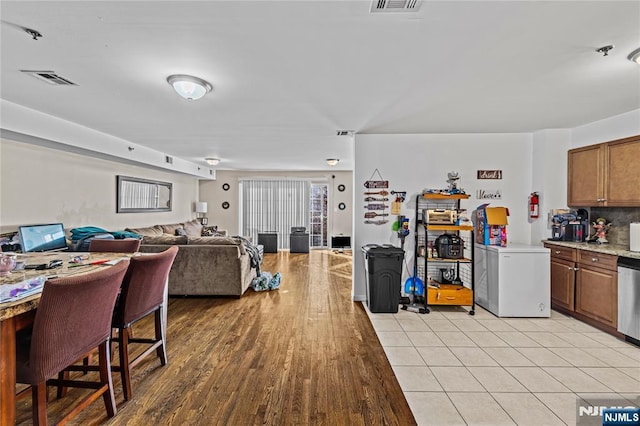 interior space featuring light wood-style flooring and visible vents