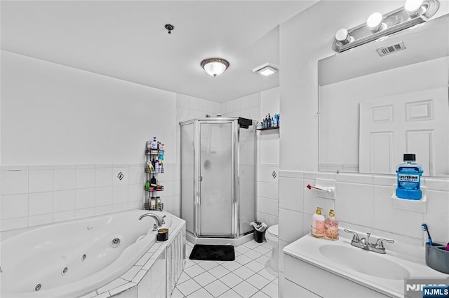 full bathroom featuring a tub with jets, a stall shower, toilet, and visible vents