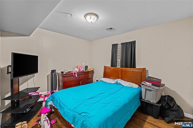 bedroom with visible vents and wood finished floors