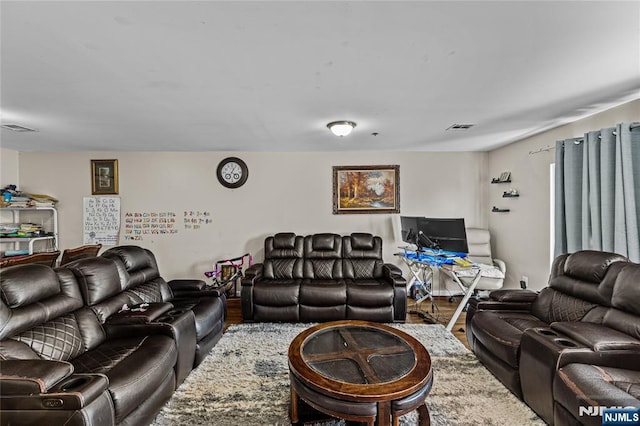 living room with wood finished floors and visible vents