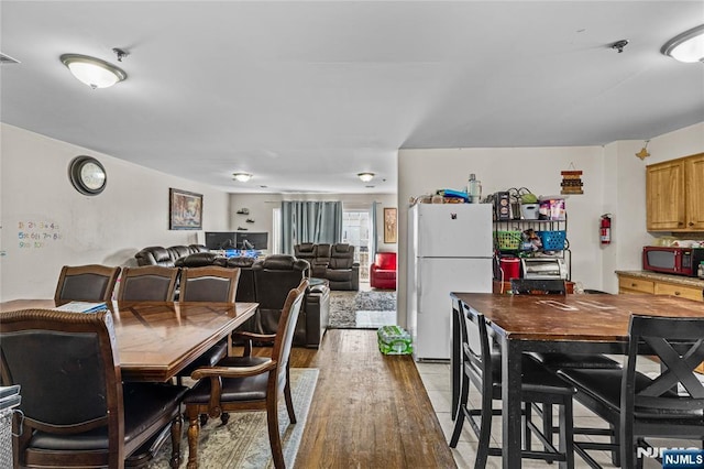 dining room with visible vents and light wood-type flooring