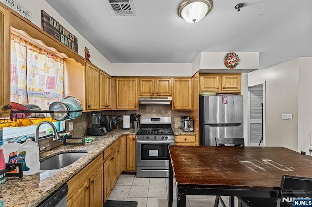 kitchen with visible vents, under cabinet range hood, light tile patterned floors, appliances with stainless steel finishes, and a sink