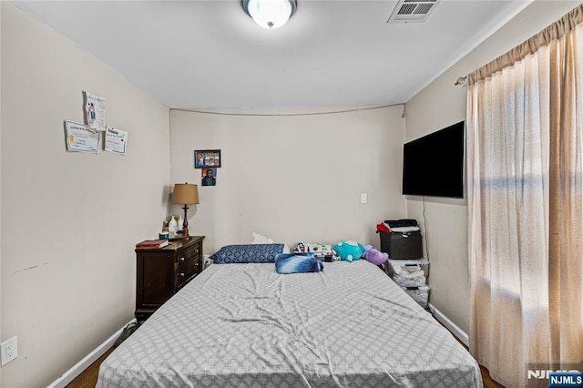 bedroom featuring visible vents and baseboards