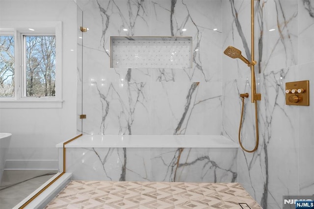 details featuring a marble finish shower and a tub with marble appearance