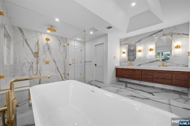 bathroom featuring visible vents, a freestanding bath, double vanity, marble finish floor, and stone wall