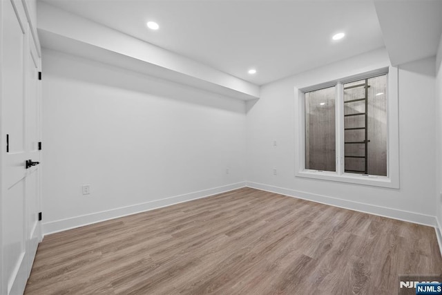 interior space with recessed lighting, wood finished floors, and baseboards