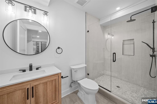 bathroom with visible vents, a shower stall, toilet, and vanity