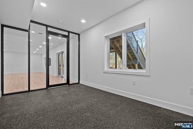 unfurnished room featuring recessed lighting and baseboards