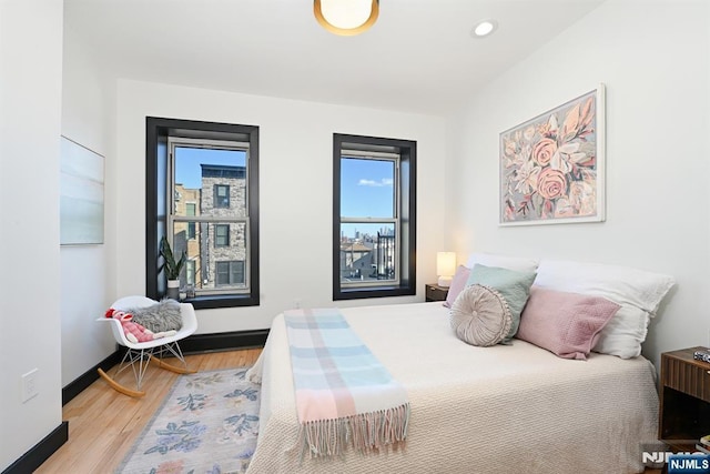 bedroom featuring recessed lighting, baseboards, and light wood-style floors