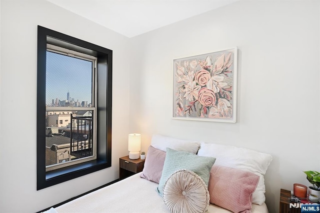 bedroom featuring a city view