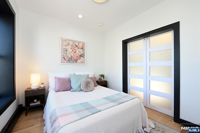 bedroom featuring recessed lighting and light wood-style flooring