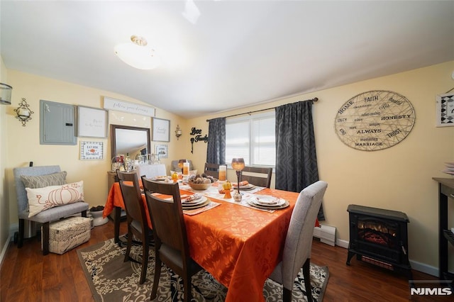 dining area featuring lofted ceiling, electric panel, wood finished floors, and baseboards