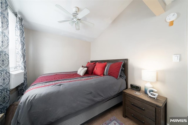 bedroom with ceiling fan, carpet, and vaulted ceiling