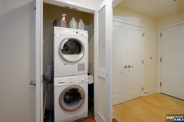 clothes washing area featuring laundry area and stacked washer / drying machine