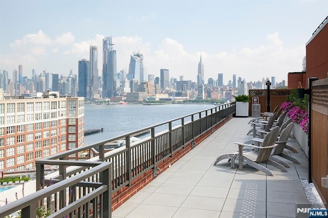 view of patio featuring a city view and a water view