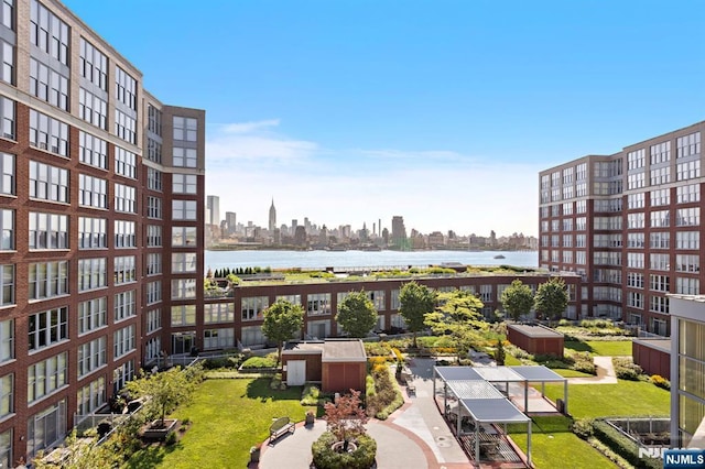 exterior space with a city view and a water view