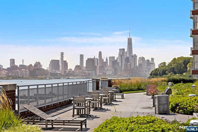 view of patio featuring a view of city and a water view