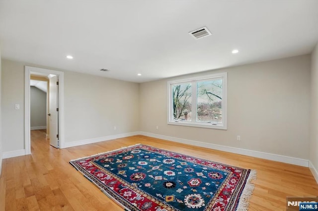empty room featuring light wood finished floors, baseboards, visible vents, and recessed lighting