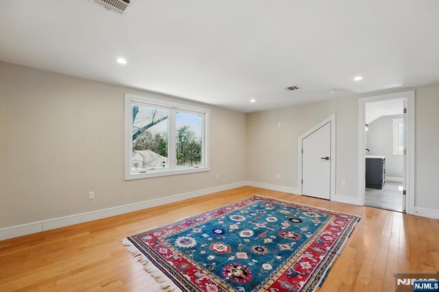 interior space featuring light wood-style flooring, baseboards, visible vents, and recessed lighting