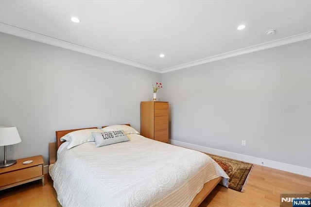 bedroom featuring baseboards, ornamental molding, recessed lighting, and wood finished floors