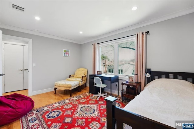bedroom with recessed lighting, crown molding, visible vents, and wood finished floors
