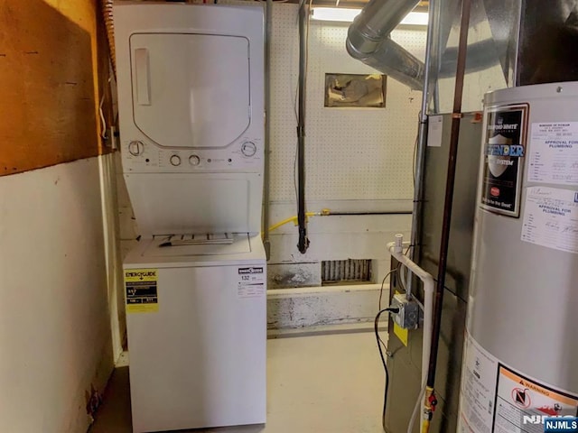 laundry room with stacked washer / drying machine and water heater