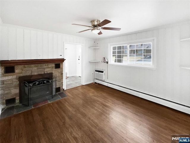 unfurnished living room featuring ceiling fan, a fireplace, wood finished floors, a wall mounted AC, and a baseboard radiator