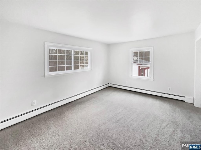 unfurnished room with carpet and baseboard heating