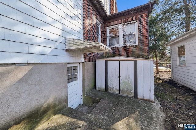 doorway to property featuring brick siding