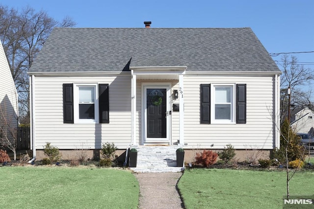 cape cod-style house featuring a front lawn and a shingled roof