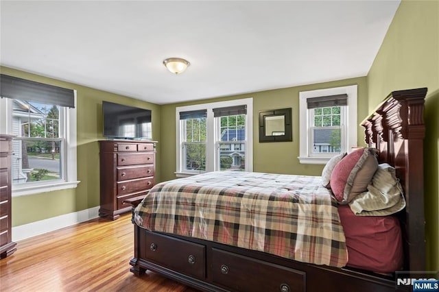 bedroom featuring baseboards and wood finished floors