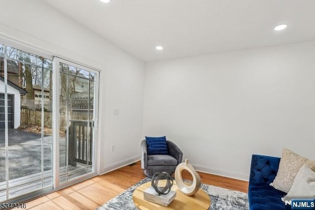 sitting room with recessed lighting, wood finished floors, and baseboards