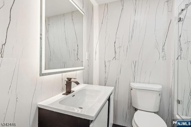 bathroom featuring toilet and vanity