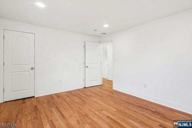 unfurnished bedroom with recessed lighting, baseboards, and light wood-style floors