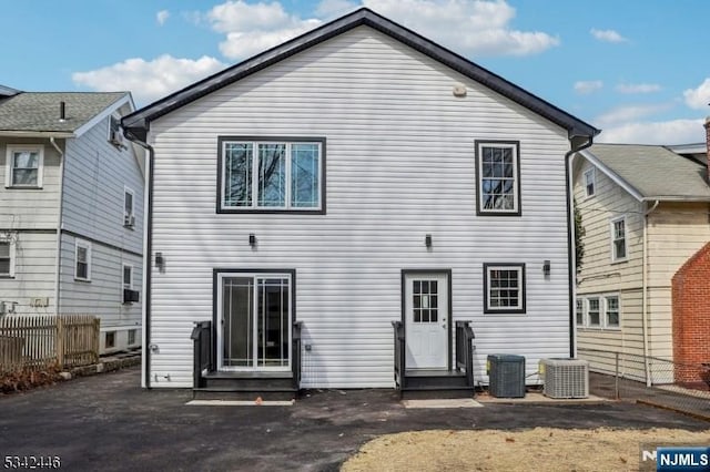 rear view of house featuring central air condition unit, a patio, fence, and entry steps