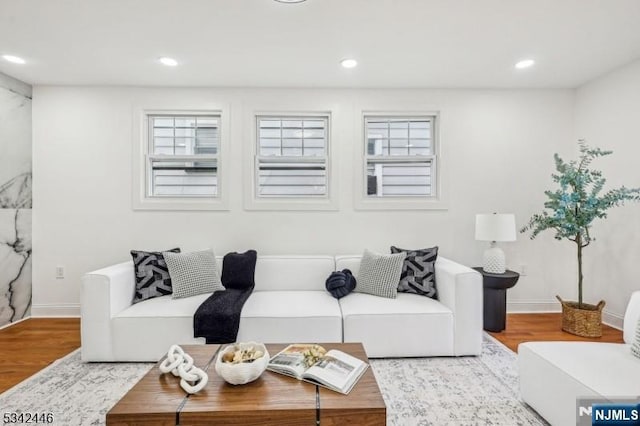 living room with plenty of natural light, recessed lighting, and wood finished floors