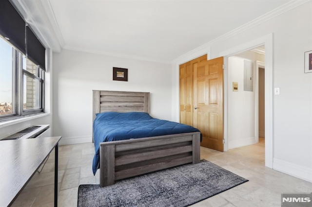 bedroom with stone tile floors, baseboards, and ornamental molding