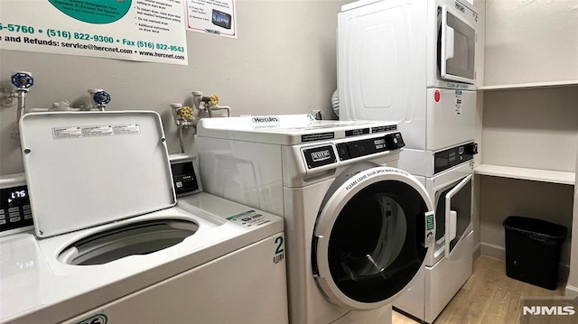 common laundry area with washer and dryer, stacked washer / dryer, and light wood finished floors