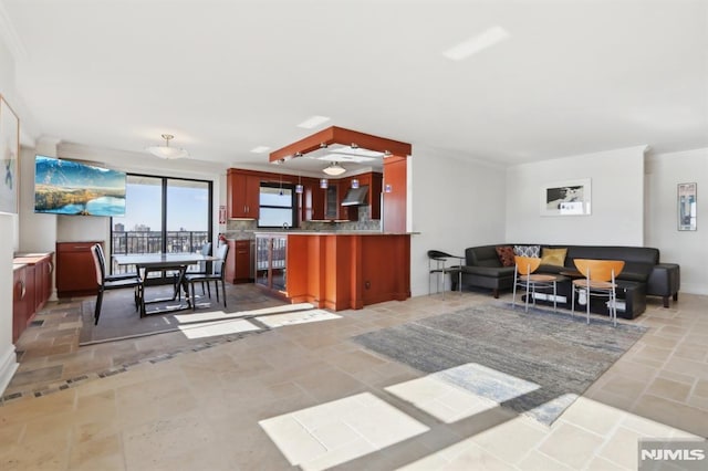 interior space featuring baseboards, crown molding, and stone finish floor