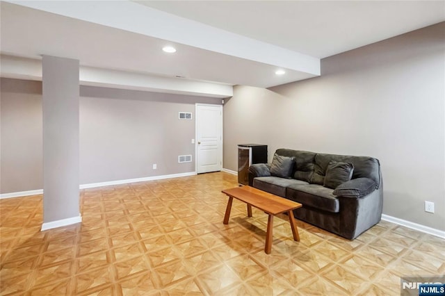 living area with recessed lighting, visible vents, and baseboards