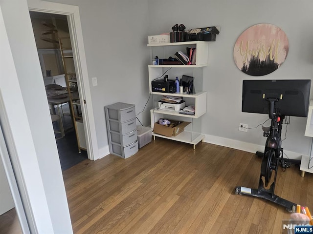 office featuring baseboards and hardwood / wood-style floors