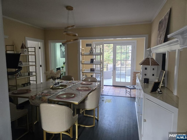 dining room with french doors, wood-type flooring, and ornamental molding