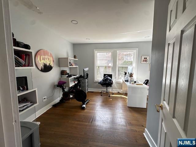 office area with baseboards and wood finished floors