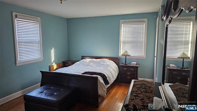 bedroom featuring baseboards and wood finished floors