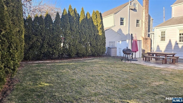 rear view of property featuring a patio and a yard