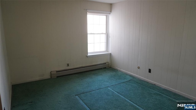 spare room with baseboards, baseboard heating, and carpet