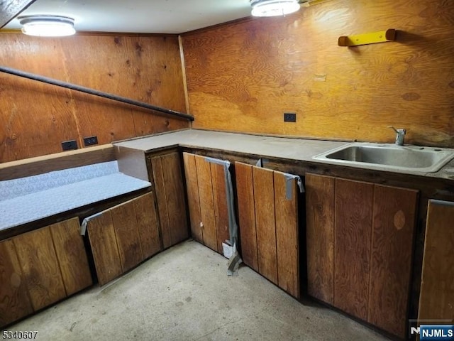 kitchen with brown cabinetry and a sink