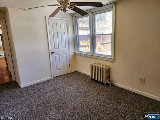 unfurnished bedroom featuring carpet flooring, radiator, and baseboards