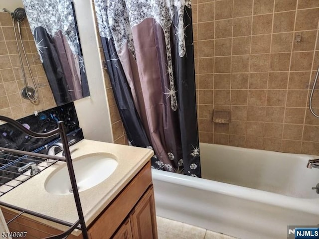 bathroom with shower / bathtub combination with curtain and vanity